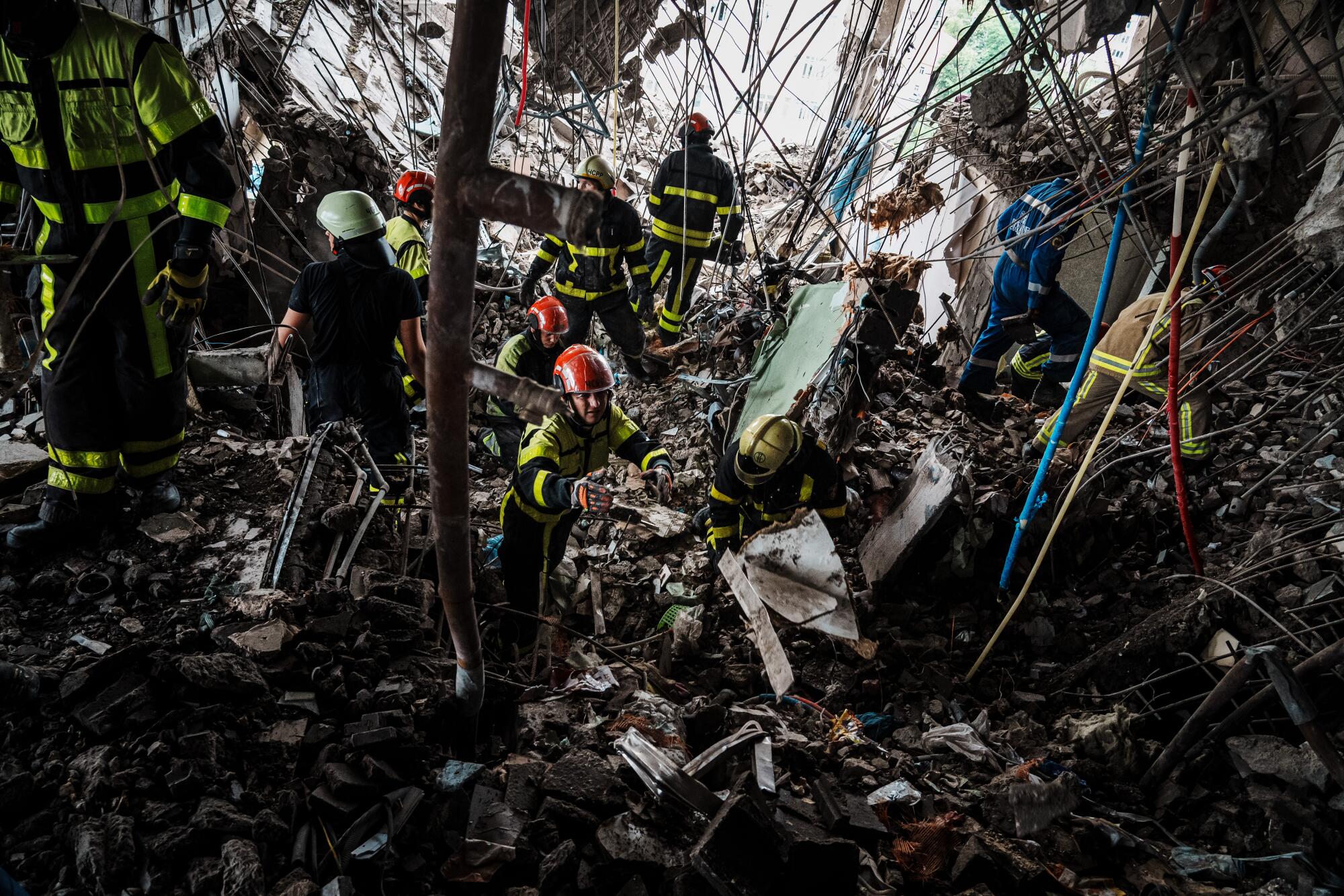 Rescuers search for victims in the rubble of a destroyed building