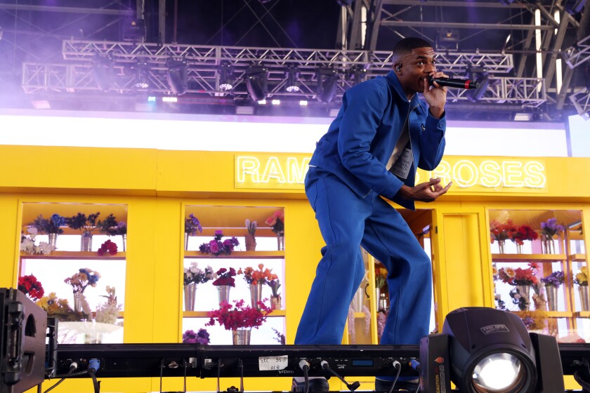 Vince Staples in a blue suit, singing at Coachella.