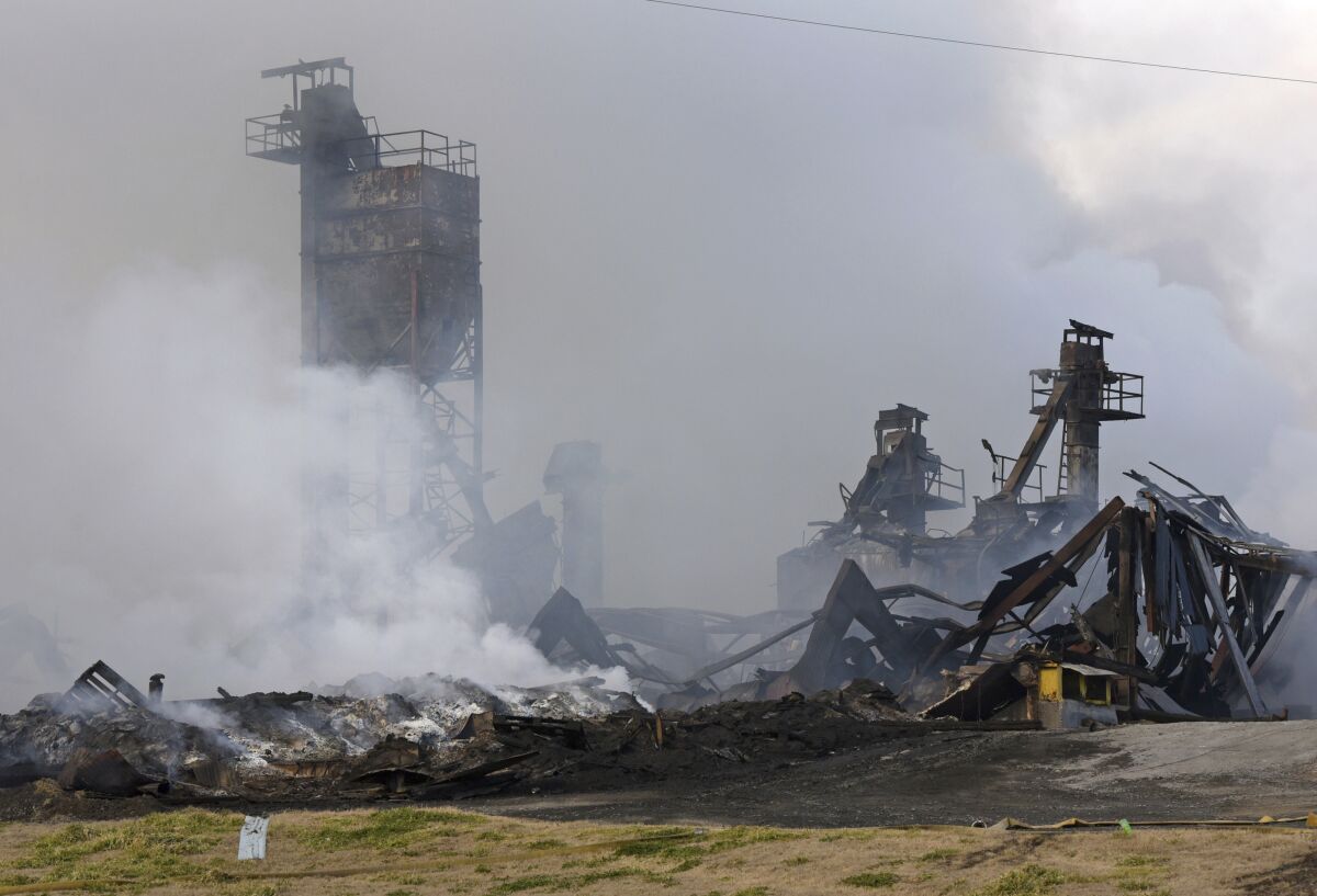 The Winston Weaver Co. fertilizer plant in Winston-Salemm N.C., continues to burn, Wednesday, Feb. 2, 2022, after the fire started Monday night. Fire officials said they could not predict when the blaze might die down. And they didn't know how many people have actually obeyed the evacuation order. (Walt Unks/The Winston-Salem Journal via AP)