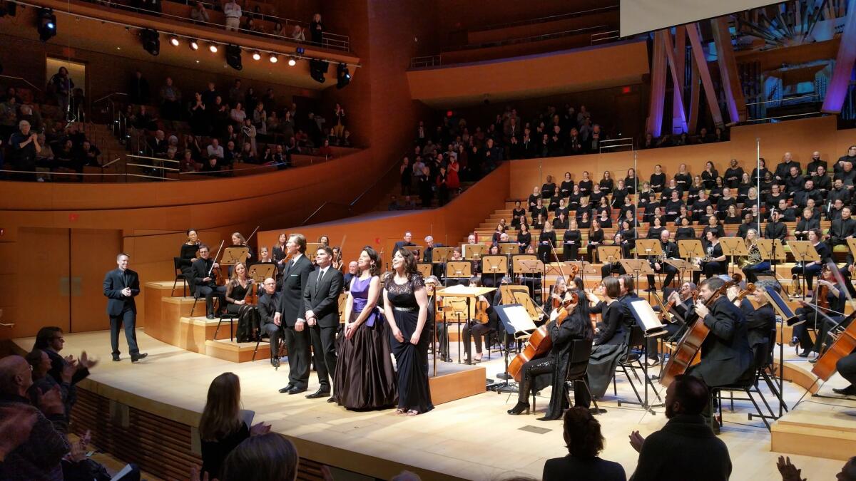 Conductor Grant Gershon, far left, of the L.A. Master Chorale, joins singers Rod Gilfry, Arnold Livingston Geis, Allyson McHardy and Raquel Gonzalez, for a bow at Disney Hall.