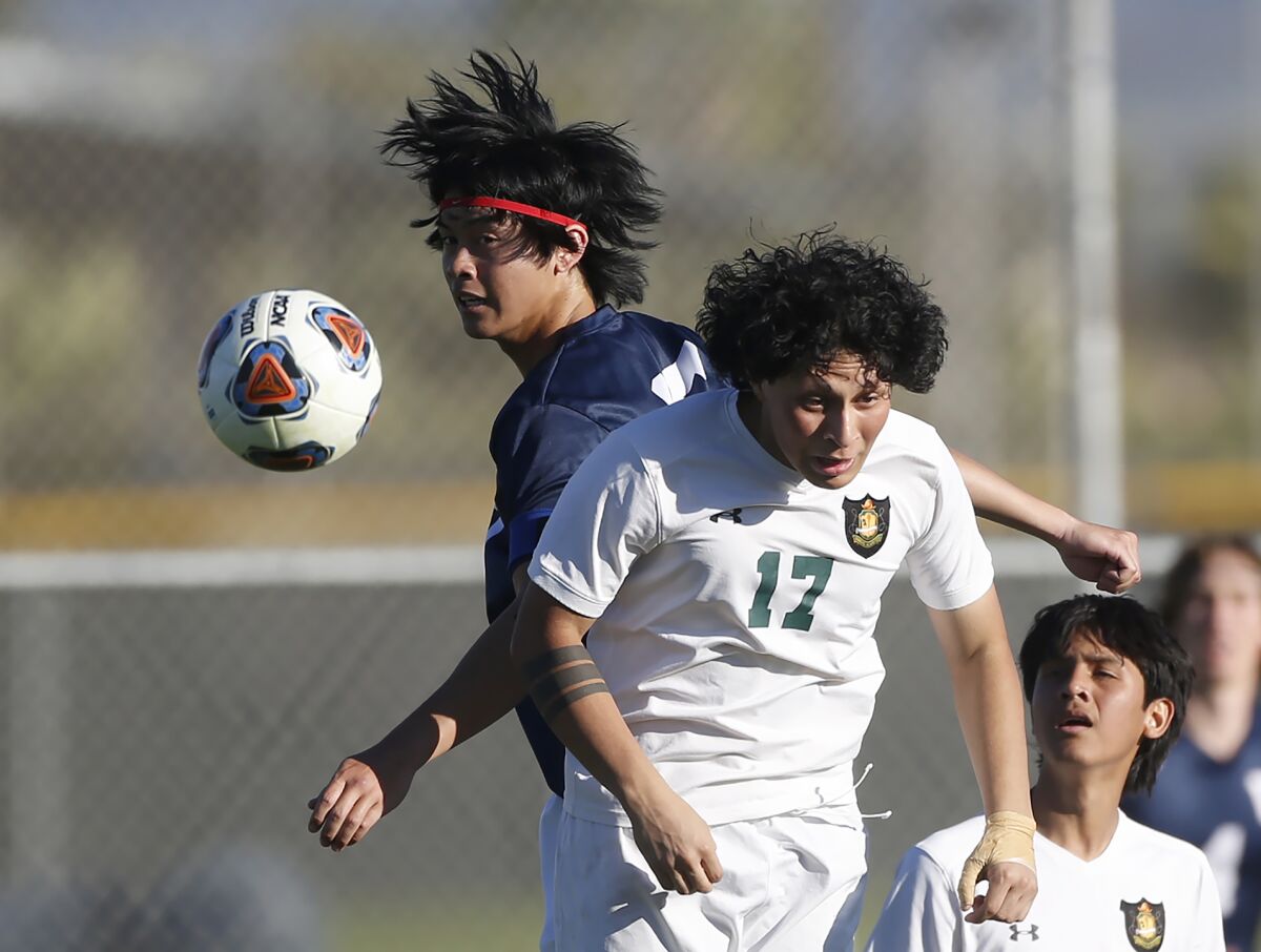 Waldorf School's Brandon Wang heads the ball toward the goal over Rancho Alamitos defender Alex Zuniga (17) on Tuesday.