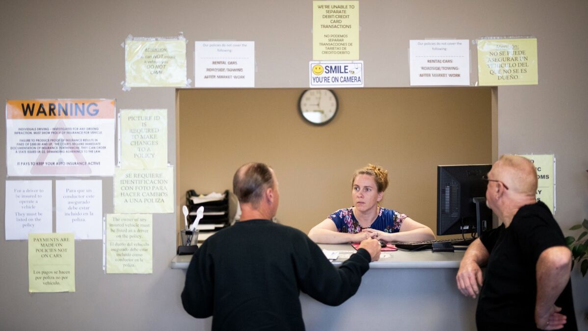 Clarisa Corber at work at a Topeka, Kan., insurance agency. She drives for Uber on Friday and Saturday nights to make extra cash, leaving when her children go to bed.