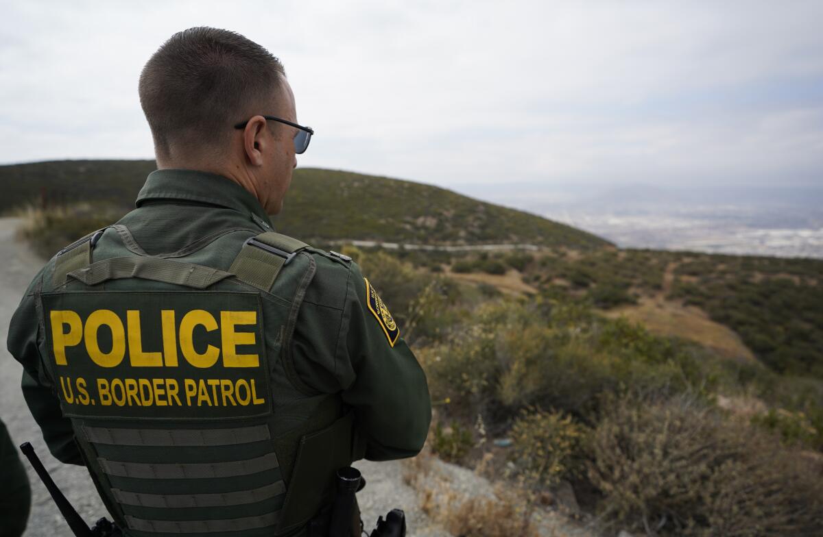 A Border Patrol agent looks out over the Otay Mountain Wilderness near the U.S.-Mexico border.