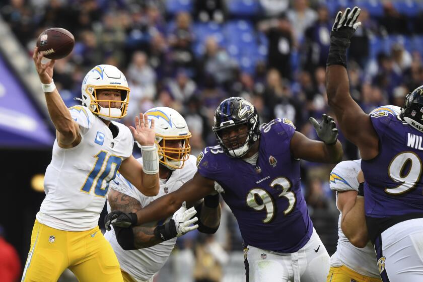 Los Angeles Chargers quarterback Justin Herbert (10) looks to pass the ball during the fourth quarter of an NFL football game against the Baltimore Ravens, Sunday, Oct. 17, 2021, in Baltimore, Md. (AP Photo/Terrance Williams)