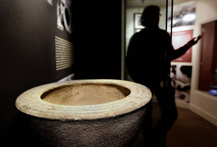 Michael De Marsche, executive director of the Catalina Island Museum, stands near an urn found by Ralph Glidden that's part of the new Glidden exhibit at the museum in Avalon. Bones are not part of the exhibit.