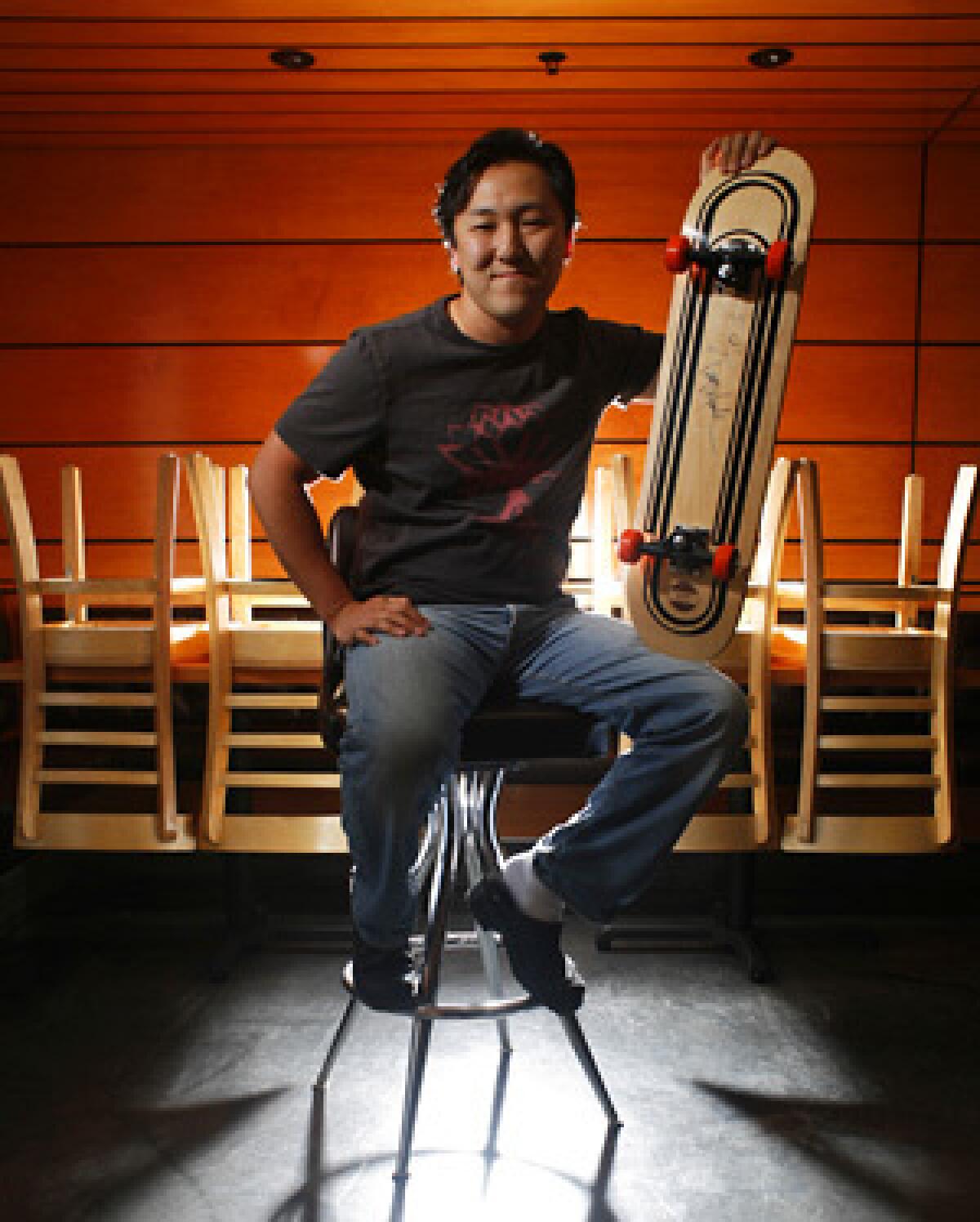 NOT FOR RIDING: Sang Yoon, owner and chef of Fathers Office, brings out his prize board signed by skater Tony Hawk.