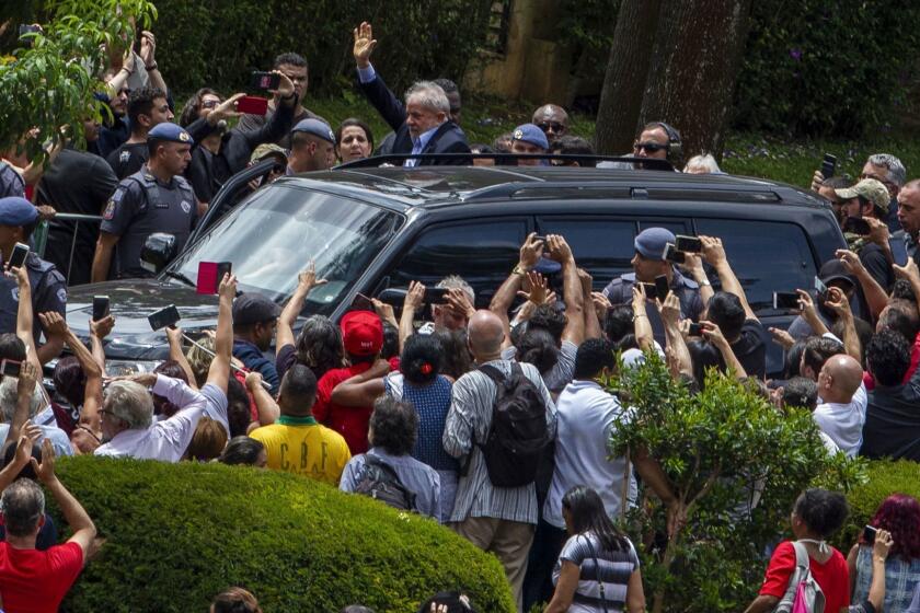 Brazilian former president (2003-2011) Luiz Inacio Lula da Silva (C) waves to supporters as he leaves the Jardim da Colina cemetery, in Sao Bernardo do Campo, Sao Paulo, Brazil where he attended his grandson's funeral on March 2, 2019, after a federal court authorised his release for a few hours from the Federal Police headquarters in Curitiba, Parana state, where he is serving a 12-year prison sentence. - Brazil's jailed former president Luiz Inacio Lula da Silva on Friday was granted leave from prison to attend the weekend funeral of his young grandson, who died at the age of seven. (Photo by Miguel SCHINCARIOL / AFP)MIGUEL SCHINCARIOL/AFP/Getty Images ** OUTS - ELSENT, FPG, CM - OUTS * NM, PH, VA if sourced by CT, LA or MoD **