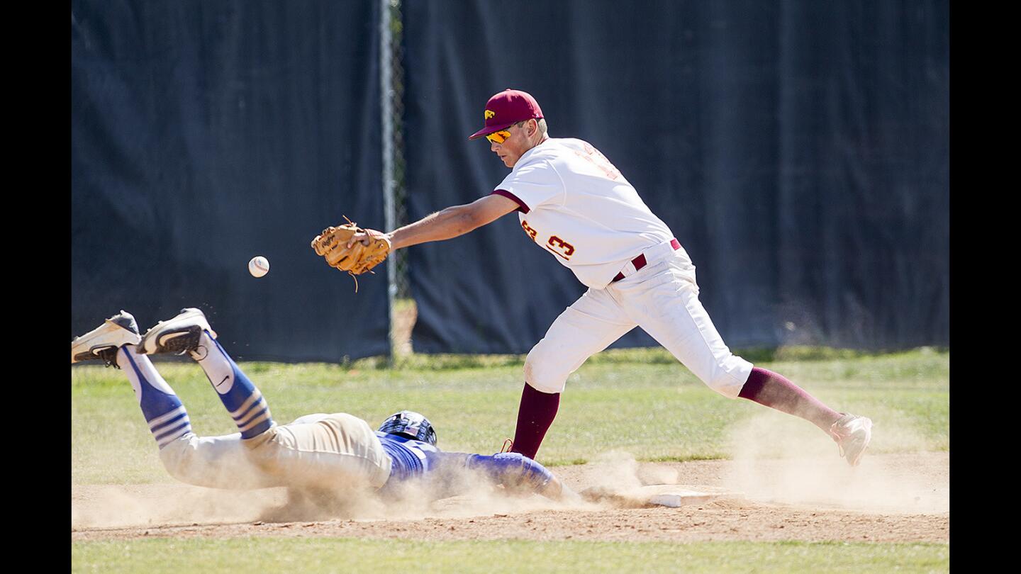 Estancia's Joe Stukkie can't handle a throw to third in an attempt to keep Windward's Isaac Muñoz from getting too much of a lead during a wild-card game of the CIF Southern Section Division 5 playoffs on Tuesday, May 16. Muñoz scored on the error.