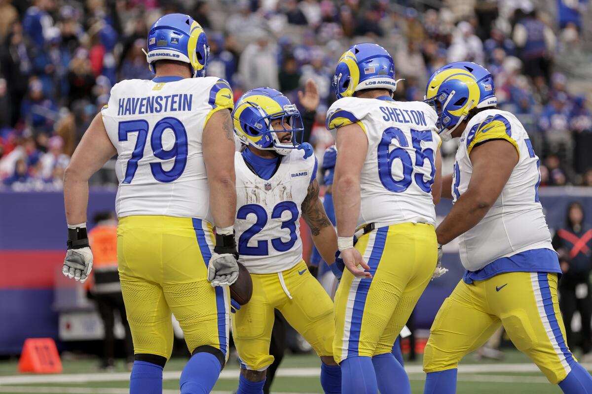 Rams running back Kyren Williams (23) celebrates one of his three touchdowns against the Giants with teammates.