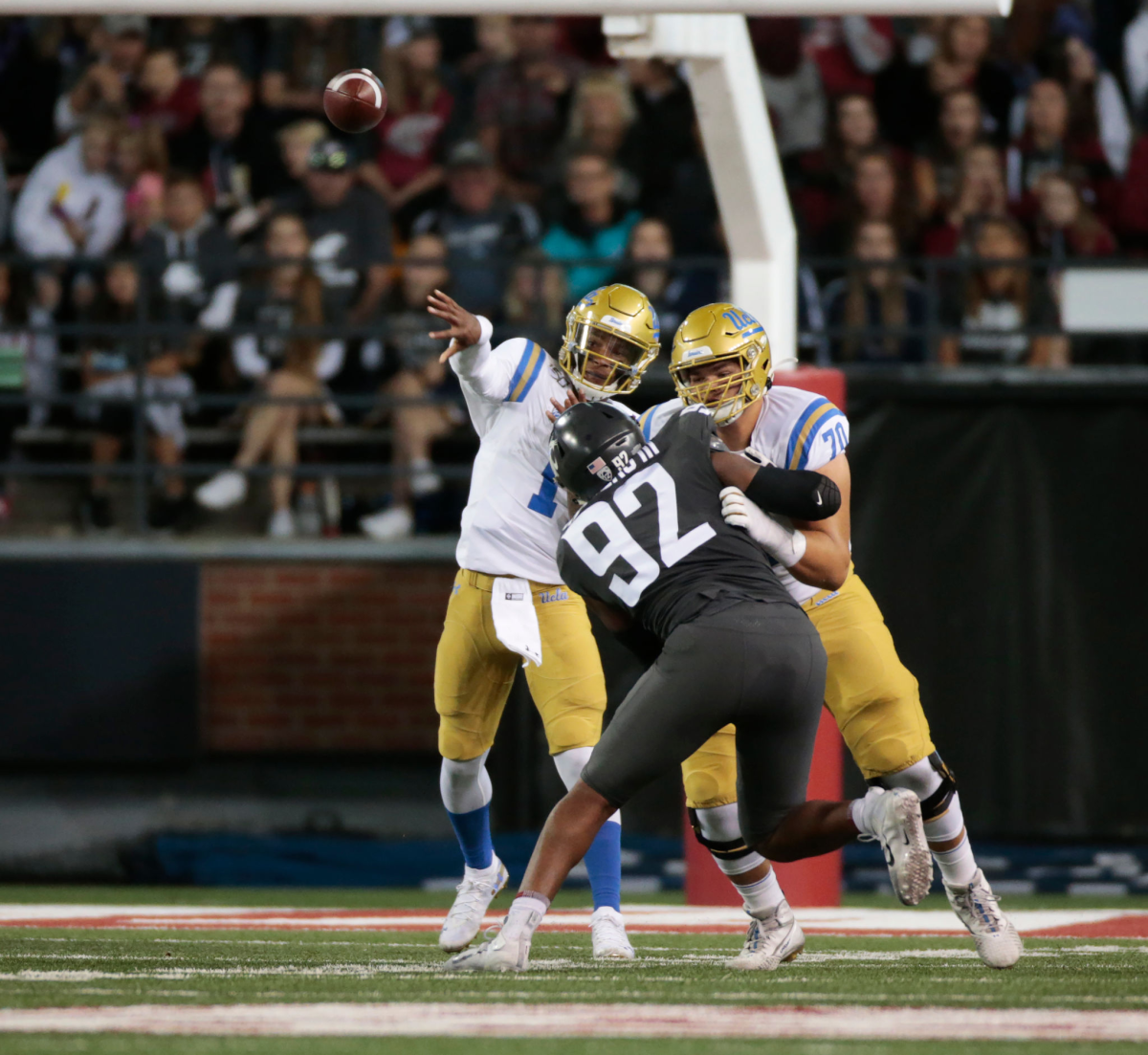 UCLA lineman Alec Anderson protects quarterback Dorian Thompson-Robinson from Washington State's Will Rodgers III in 2019.