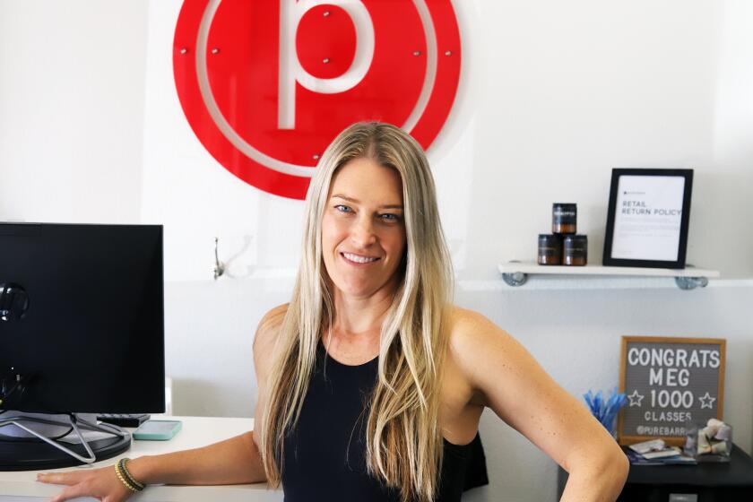 Monica Grubin, of Costa Mesa, the owner of Pure Barre, poses for a picture at Pure Barre in Huntington Beach on Tuesday, March 5, 2024. Pure Barre offers a full-body workout and mix of pilates, yoga and ballet the franchise is celebrating 15 years in business. Monica Grubin is a former NCAA division 1 women's water polo player. (Photo by James Carbone)