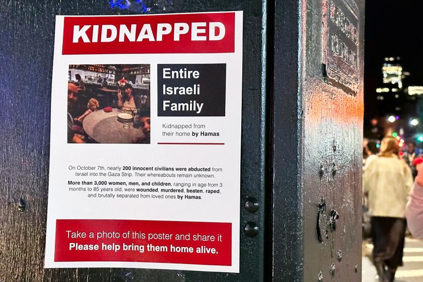 A flier on an electrical box with the words "Kidnapped: Entire Israeli family" and a photo