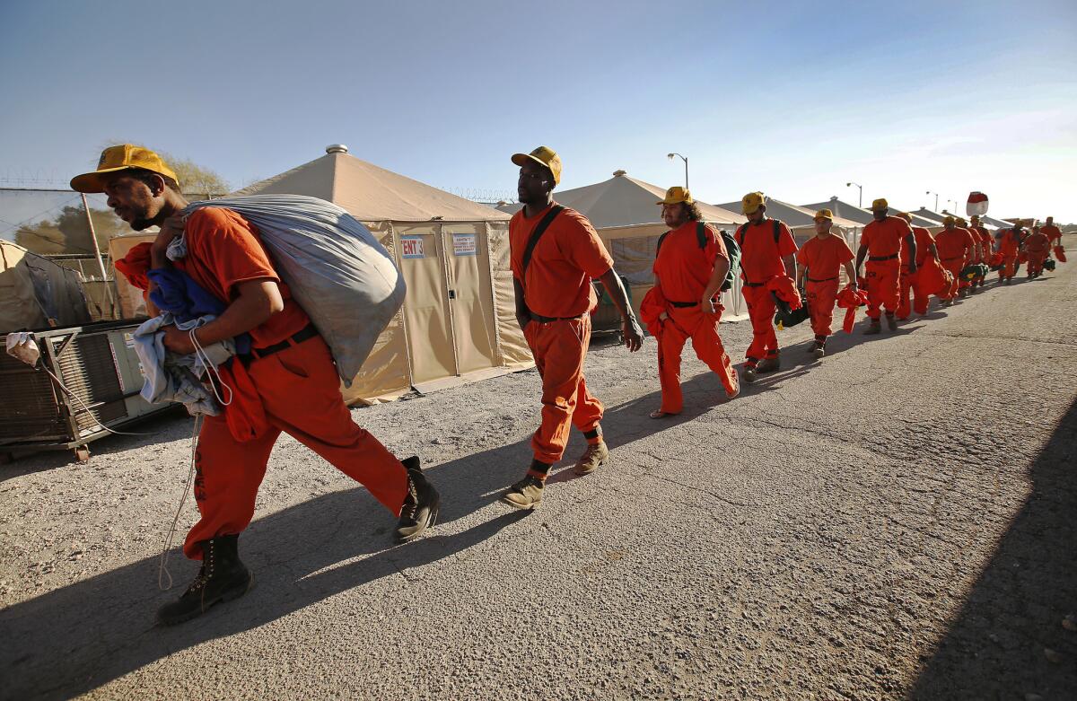 Inmates on a fire crew rest at camp after working on the Thomas fire in Ventura County on Dec. 12, 2017.