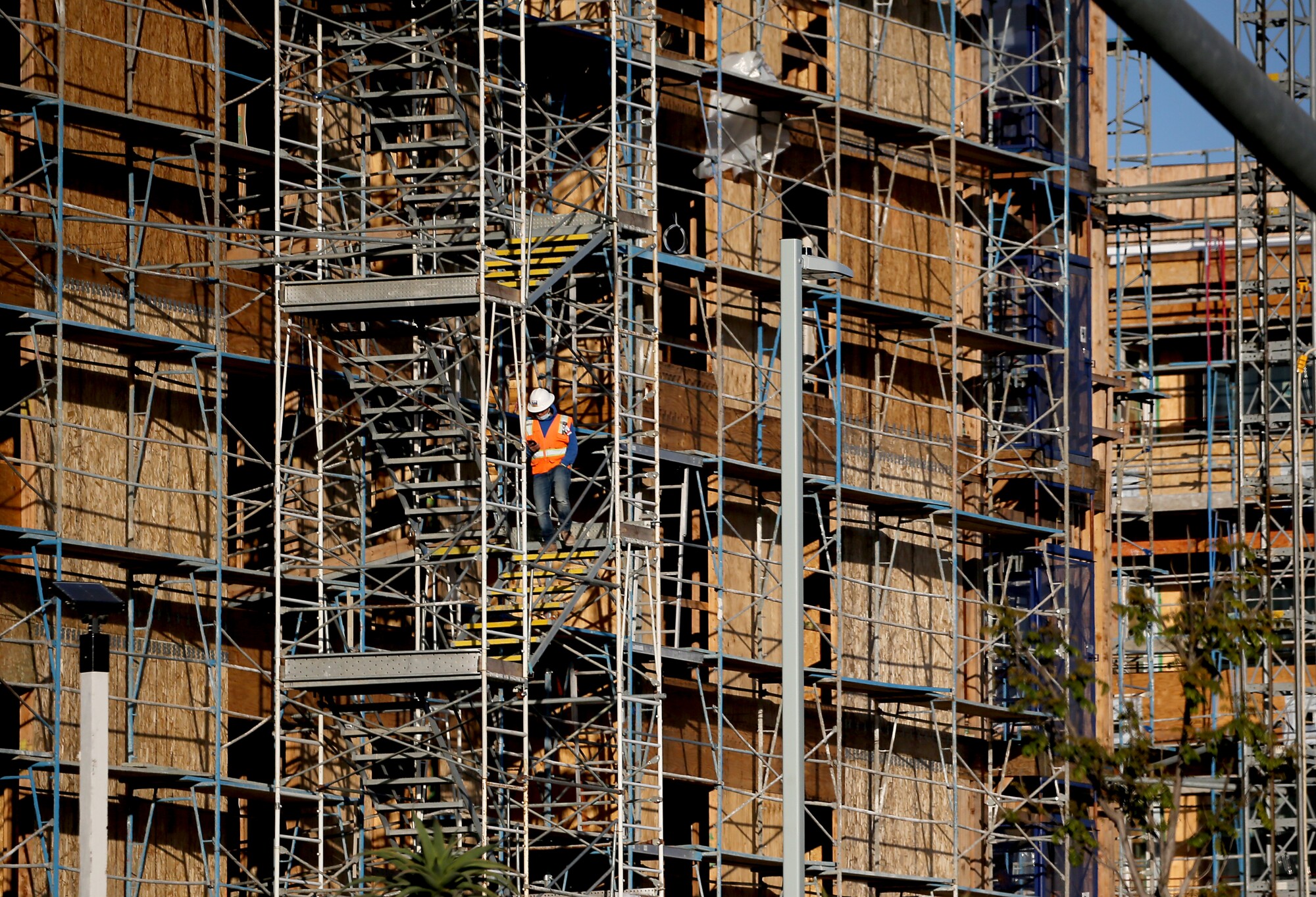 Construction workers on scaffolding outside a large building