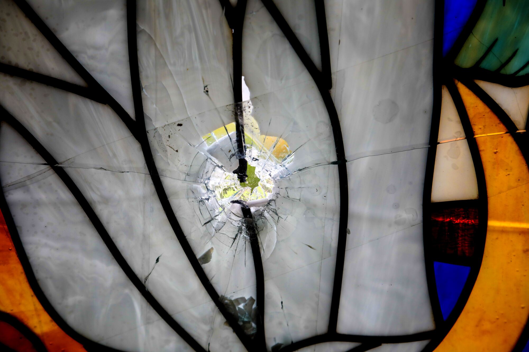 Bullet holes shattered the stained glass windows of the chapel of Parroquia Jesus de la Divina Misericordia, a Catholic church in Managua where student protesters took refuge in July 2018. The holes have been covered with new glass, but the signs of damage are preserved.