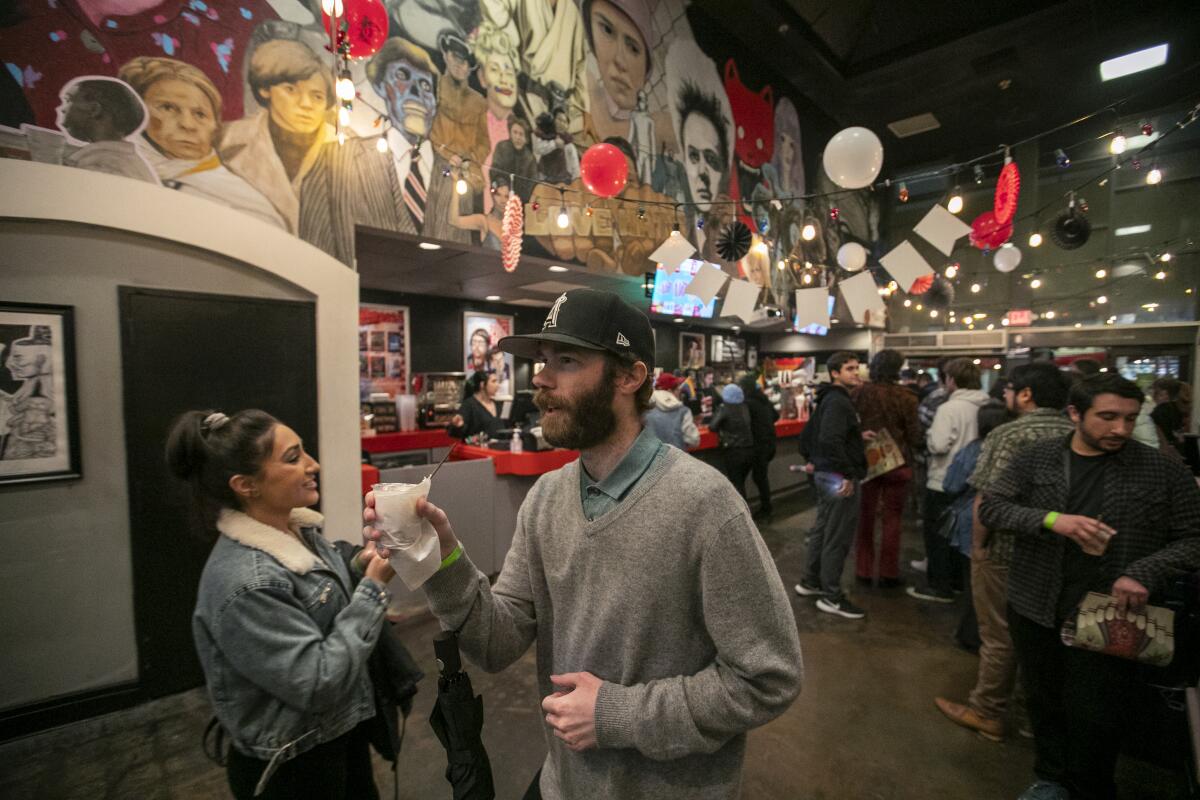 Kay Mohammad, left, and Cody Ree drink white Russians at the Frida Cinema.