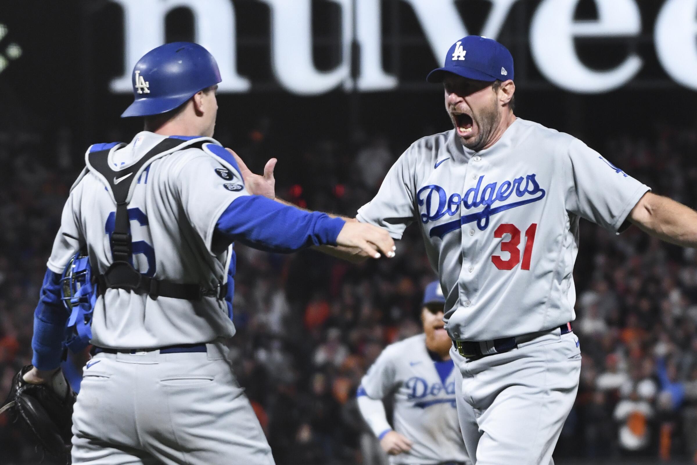 Dodgers starting pitcher Max Scherzer celebrates with Will Smith after striking out San Francisco's Wilmer Flores.