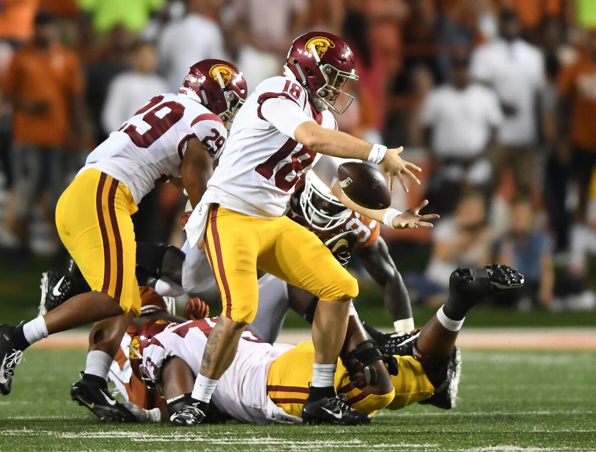 USC quarterback JT Daniels loses theball briefly while being sacked by the Texas defense in the second quarter at Royal-Texas Memorial Stadium on Saturday.