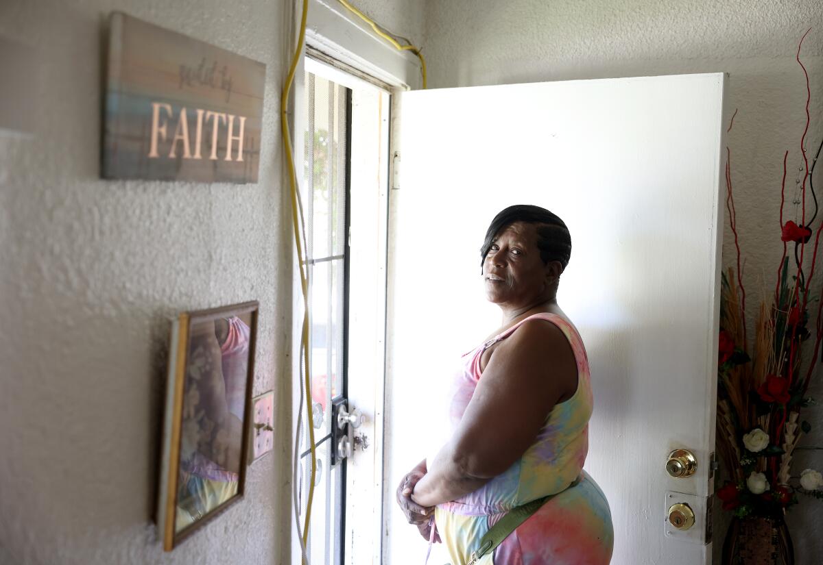 Monique Lewis stands in a doorway