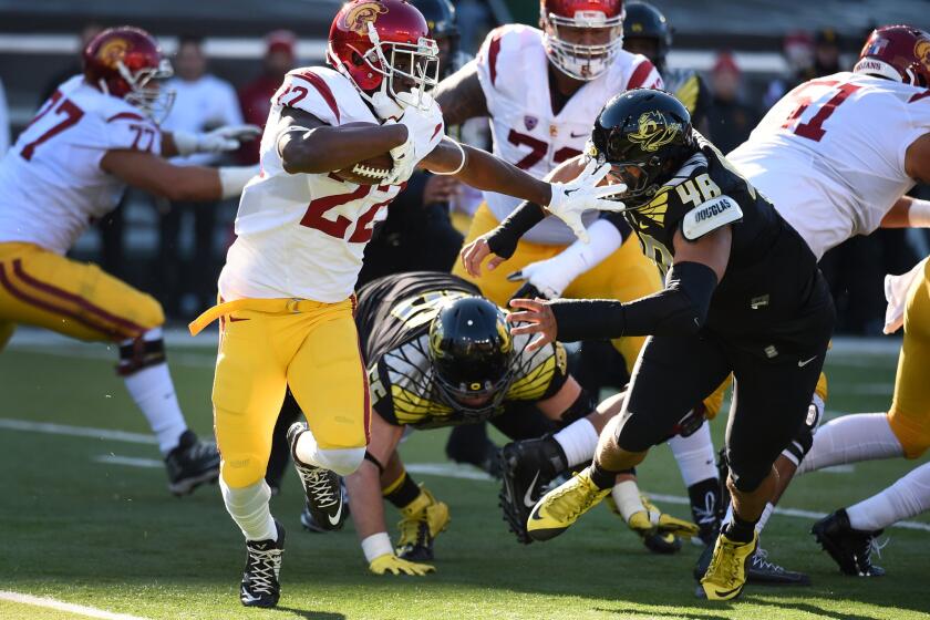 USC running back Justin Davis tries to avoid the tackle of Oregon linebacker Danny Mattingly in the first half Saturday.