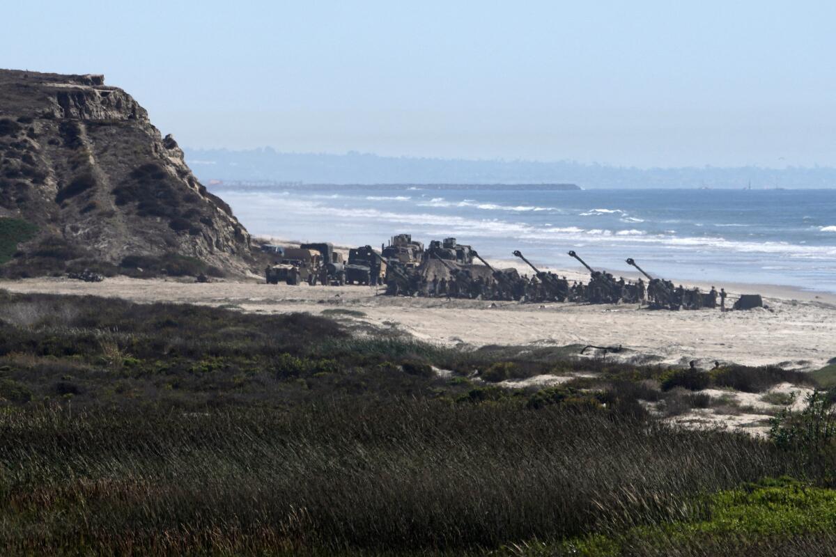 Marines conduct a military exercise on the beach.