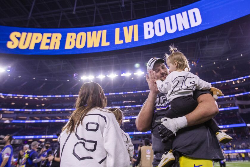 Los Angeles, CA - January 30: Rams offensive tackle Rob Havenstein gets a high-five from his daughter as he and his family celebrates their 20-17 victory over the San Francisco 49ers in the NFC Championships, winning them a berth in the Super Bowl against the Bengals at SoFi Stadium on Sunday, Jan. 30, 2022 in Los Angeles, CA. (Allen J. Schaben / Los Angeles Times)
