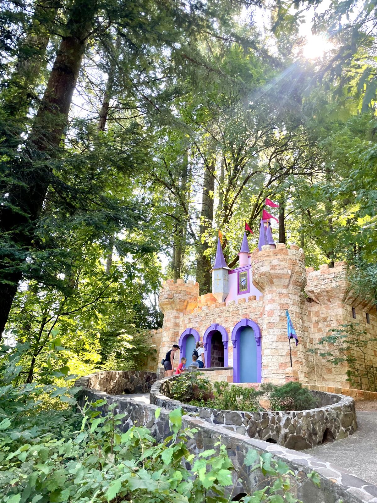 A miniature castle nestled among tall trees