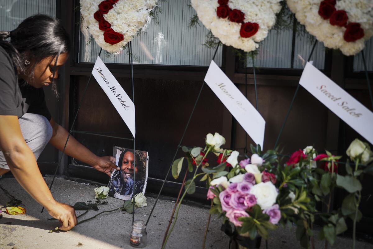 Jamila McNichols, sister of mass shooting victim Thomas "T.J." McNichols, mourns Monday at a memorial near the scene of the attack in Dayton, Ohio.