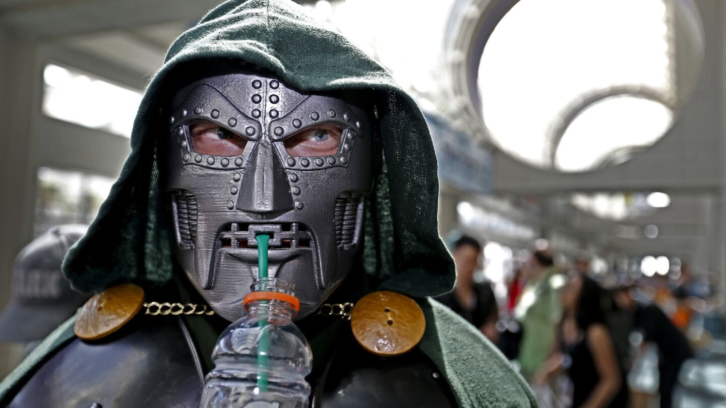 Andy Tymczyszyn of Moorpark sips Gatorade through his Dr. Doom-Fantastic 4 costume on Thursday, opening day of Comic-Con International 2017.