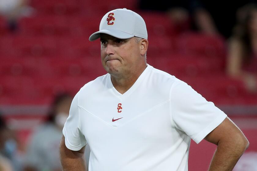 LOS ANGELES, CALIF. - SEP 11, 2021. USC head coach Clay Helton watches the Trojans warm up.