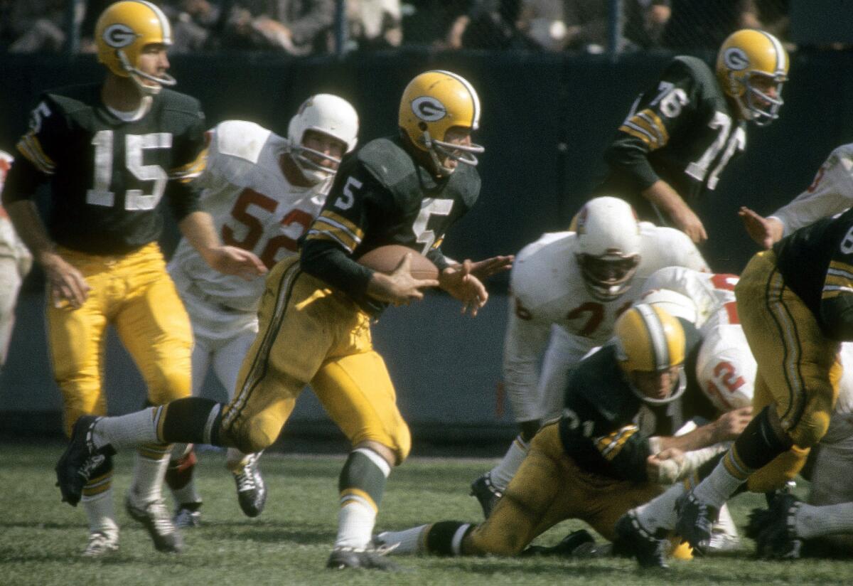 Green Bay Packers running back Paul Hornung (5)  runs against the Cardinals defense.