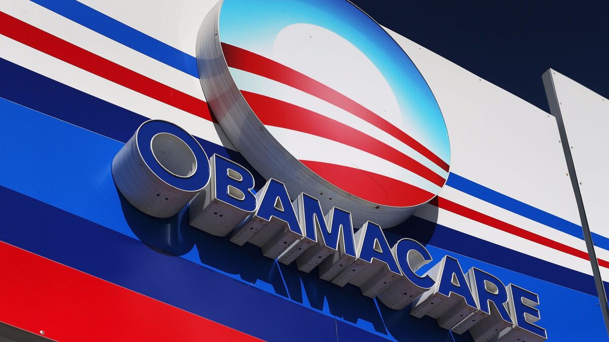 An Obamacare sign is displayed on an insurance company office in Miami last year.
