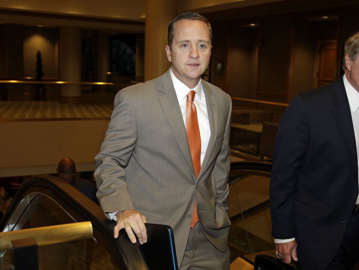 FILE - Miami athletic director Blake James walks to an NCAA Committee on Infractions hearing in Indianapolis, June 13, 2013. Boston College has hired James as its third athletic director since 2017. (AP Photo/Michael Conroy, File)