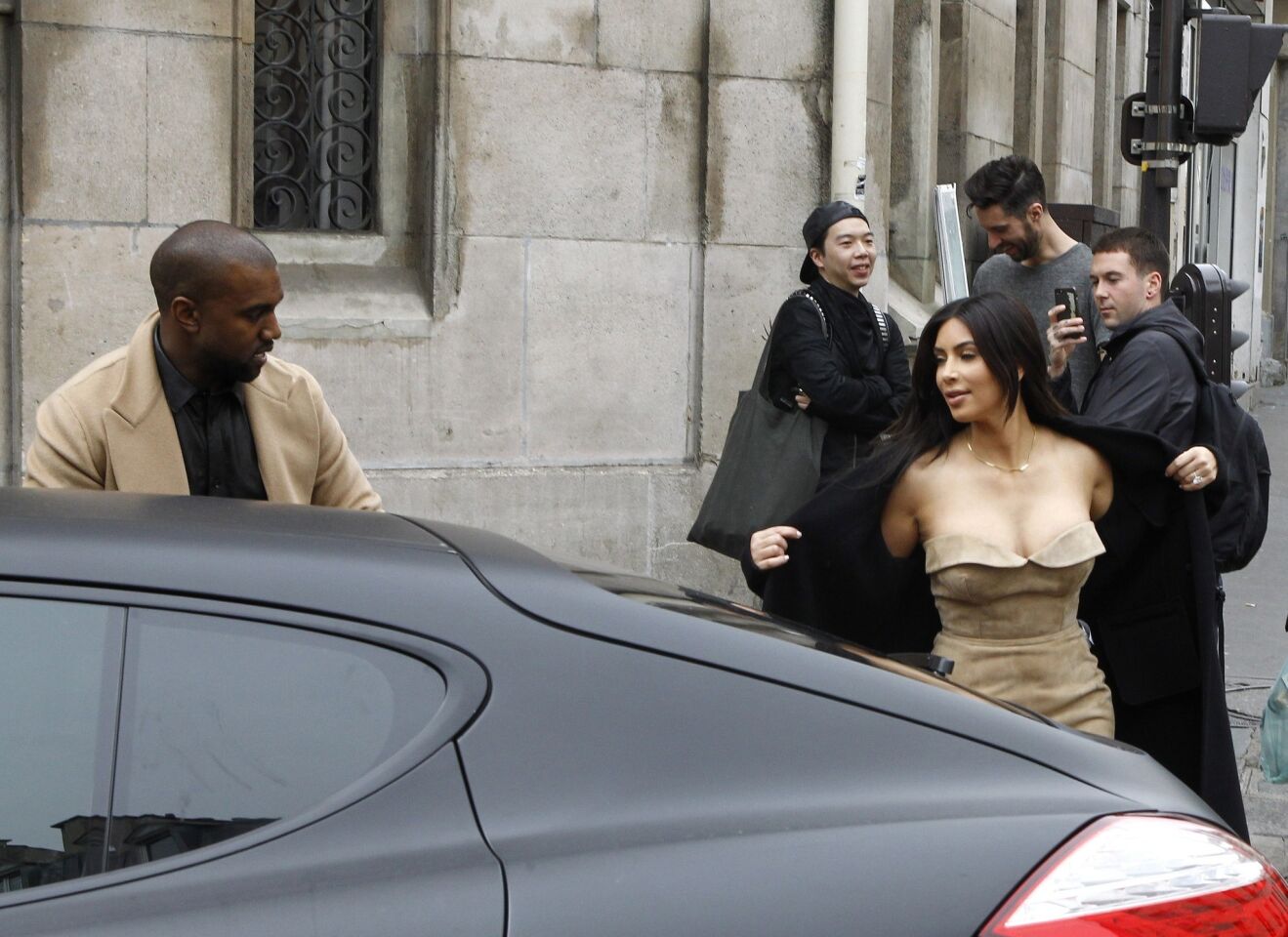 Kim Kardashian, in a strapless Ermanno Scervino dress, with fiance Kanye West in Paris on May 21.