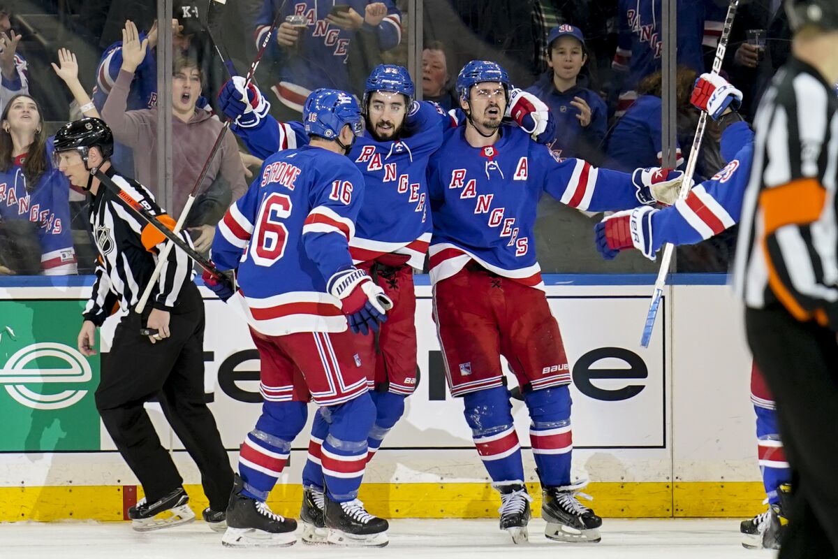 New York Rangers left wing Chris Kreider, center right, celebrates after scoring the go-ahead goal on St. Louis Blues goaltender Ville Husso (35) during the third period of an NHL hockey game, Wednesday, March 2, 2022, in New York. (AP Photo/John Minchillo)