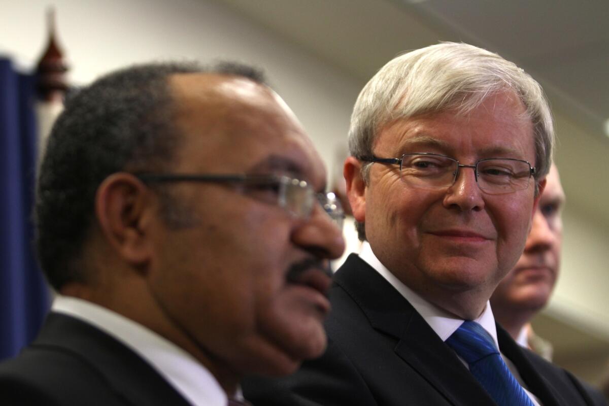 Papua New Guinea Prime Minister Peter O'Neill, left, and Australian Prime Minister Kevin Rudd announce a new policy on asylum-seekers at a news conference in Brisbane, Australia.