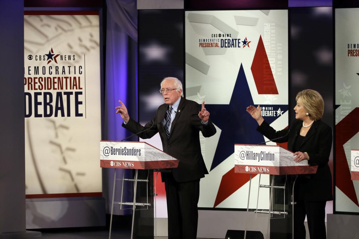 Bernie Sanders and Hillary Rodham Clinton argue during a Democratic presidential primary debate, Saturday, Nov. 14, 2015, in Des Moines, Iowa.