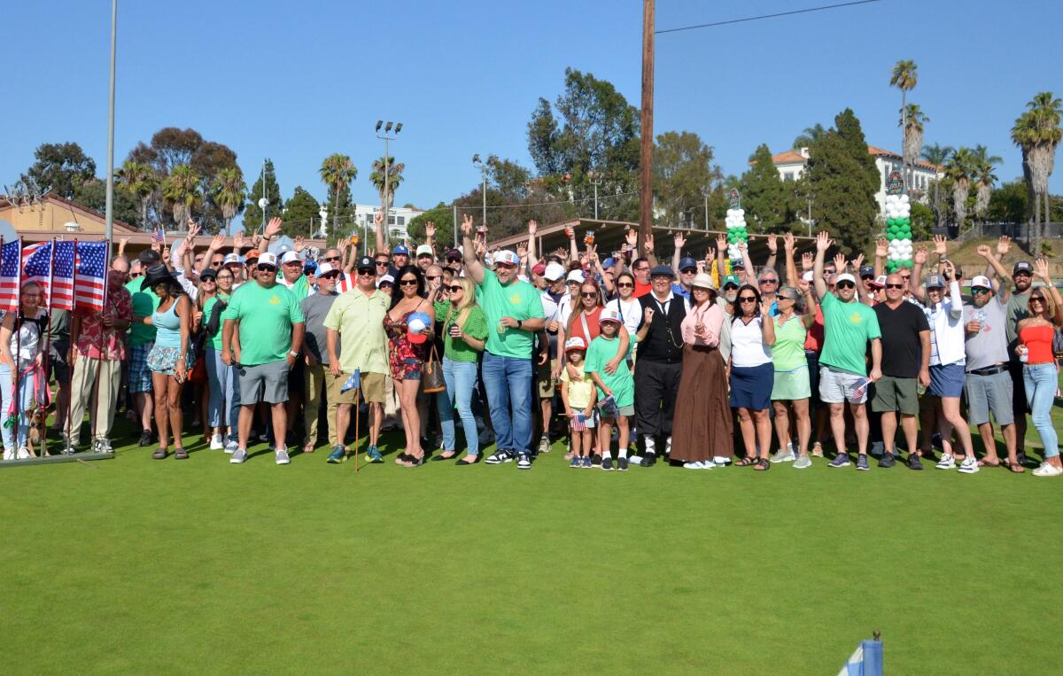Attendees at the July 3 rally to save the Newport Beach Golf Course wave to the camera.