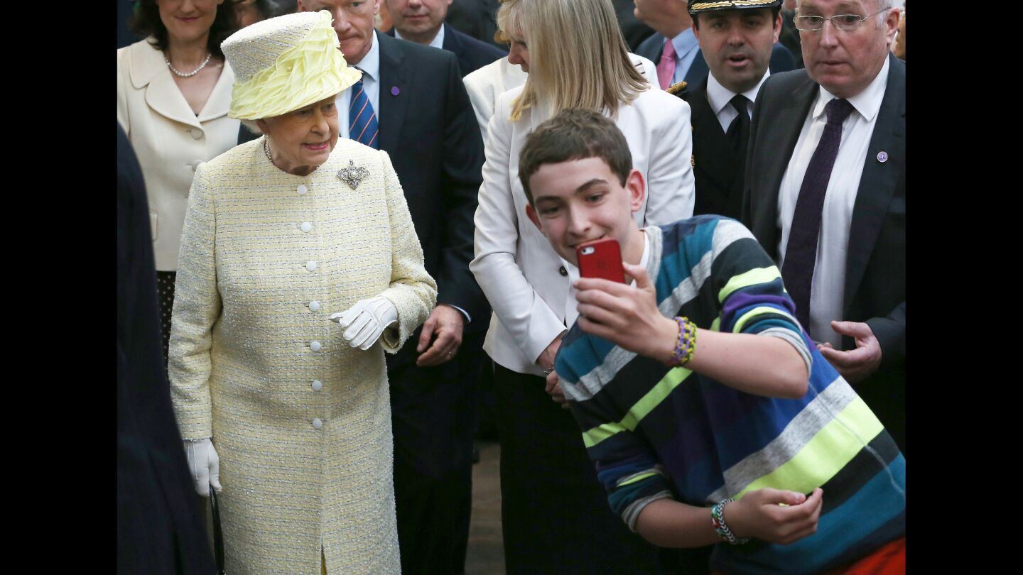 Queen Elizabeth II and a young fan in Belfast, Northern Ireland.