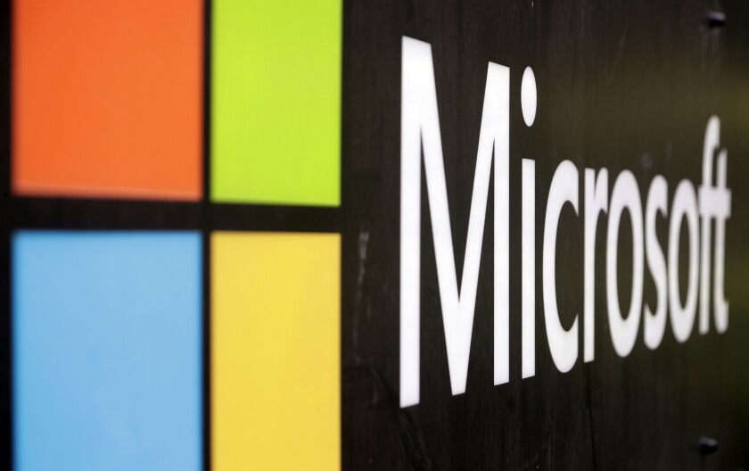 FILE - The Microsoft company logo is displayed at their offices in Sydney, Australia, on Wednesday, Feb. 3, 2021. The Competition and Markets Authority said in a brief statement Monday, Dec. 13, 2021 that British antitrust regulators are opening an investigation into Microsoft's $16 billion acquisition of speech recognition company Nuance in the latest sign they're tightening scrutiny of big technology deals. (AP Photo/Rick Rycroft, File)