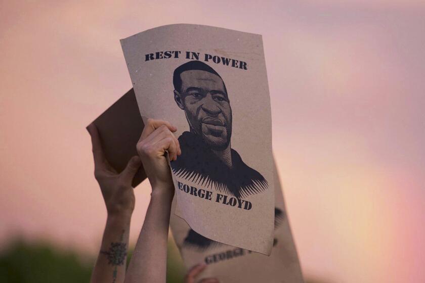 A sign featuring an image of George Floyd is displayed during a protest in Minneapolis on May 27.