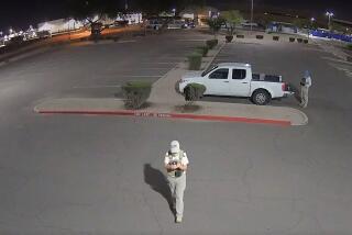 A photo shows two armed individuals at a ballot drop box in Mesa, Ariz., last week.