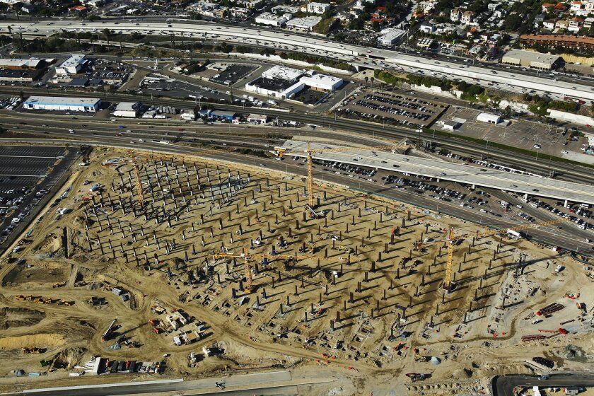 Cranes line the site where the San Diego Airport's Central Rental Car facility is being built between I-5 and the airport.
