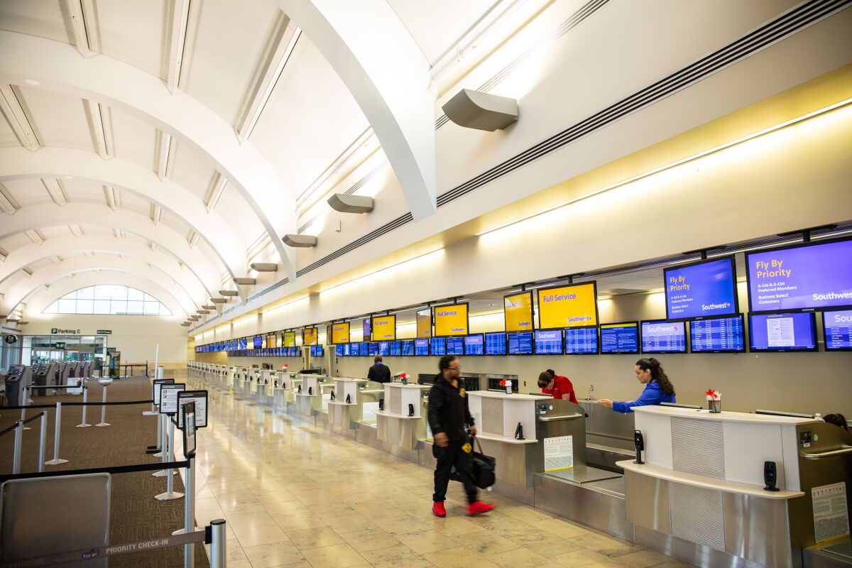 A single passenger approaches the Southwest Airlines ticket counter at John Wayne Airport on March 24, 2020. 