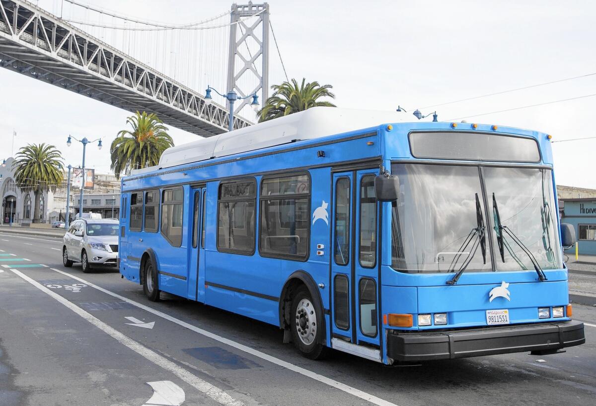 A Leap Transit bus, an alternative to the Muni network, drives under the Bay Bridge in San Francisco.