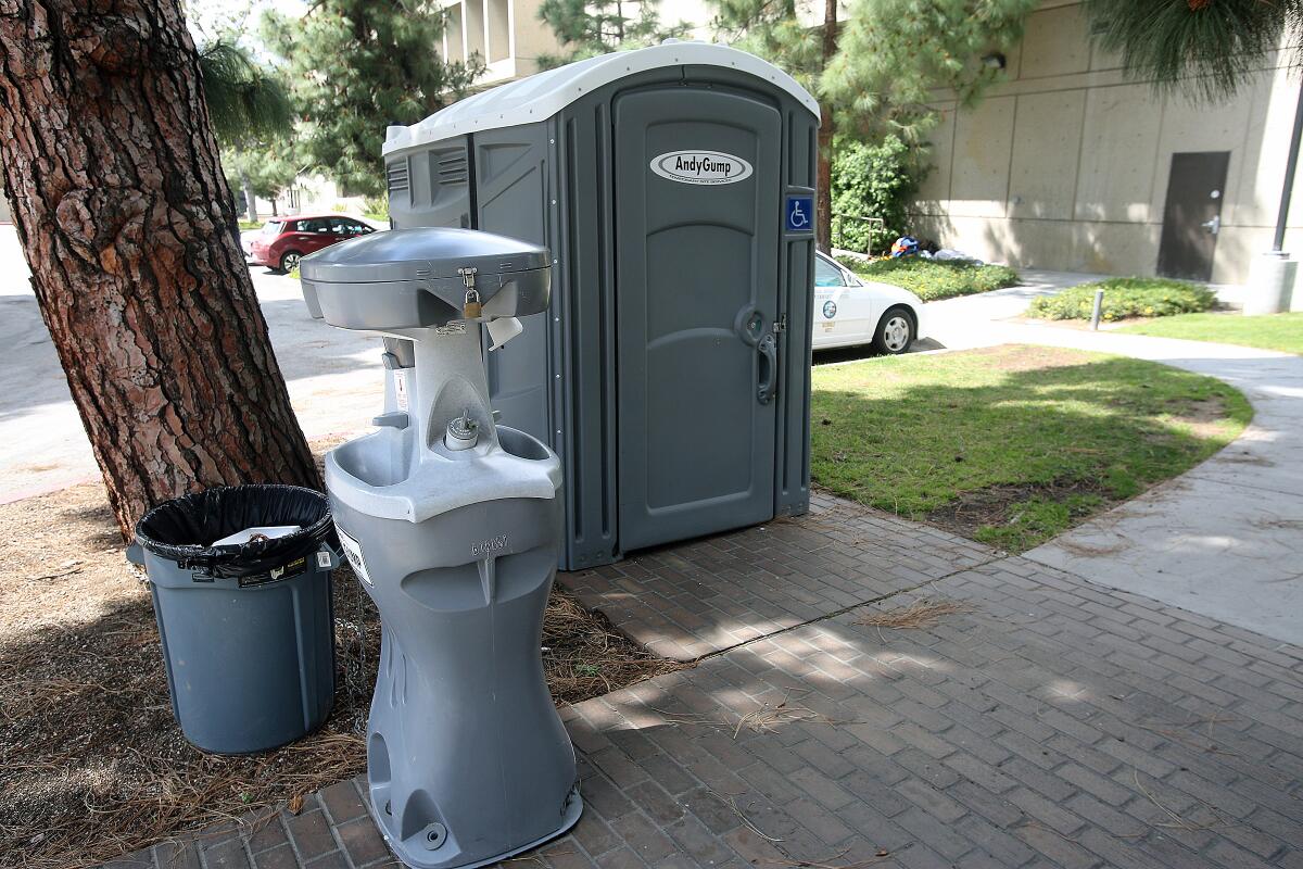 A portable toilet with a wash station between the Adult Recreation Center and the Central Library in Glendale on March 24, 2020. Portable hygiene stations have been placed in various Glendale locations for the homeless to use in lieu of city services which are now closed because of the coronavirus.