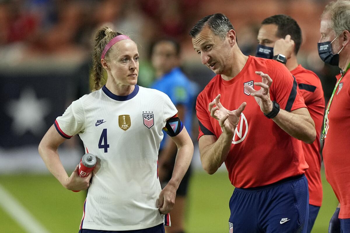 U.S. women's soccer team Coach Vlatko Andonovski, right, talks with Becky Sauerbrunn during a game