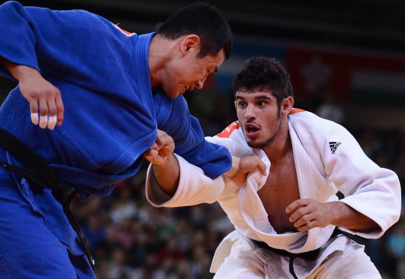 South Korea's Song Dae-nam, left, faces Cuba's Asley Gonzalez in the men's judo finals.