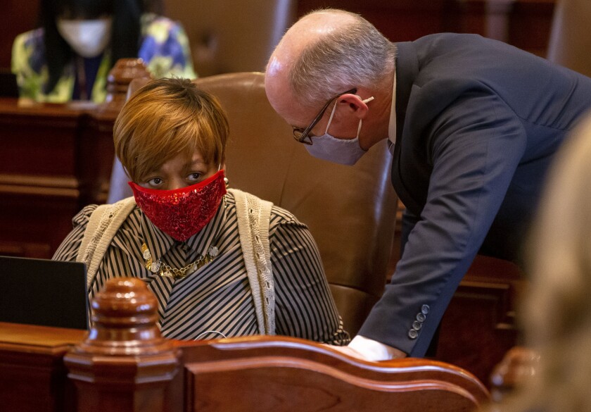 FILE - In this May 30, 2021 file photo, Illinois State Sen. Patricia Van Pelt, D-Chicago, speaks with Illinois Senate President Don Harmon, D-Oak Park, at the Illinois State Capitol in Springfield, Ill. Illinois Democrats used inadequate data and an opaque process to draw new legislative districts, a Latino civil rights organization argued in the latest lawsuit seeking to block the maps from being used for statehouse elections over the next decade. The group is suing Pritzker, House Speaker Emanuel "Chris" Welch, Senate President Don Harmon and members of the Illinois State Board of Elections. (Justin L. Fowler/The State Journal-Register via AP)