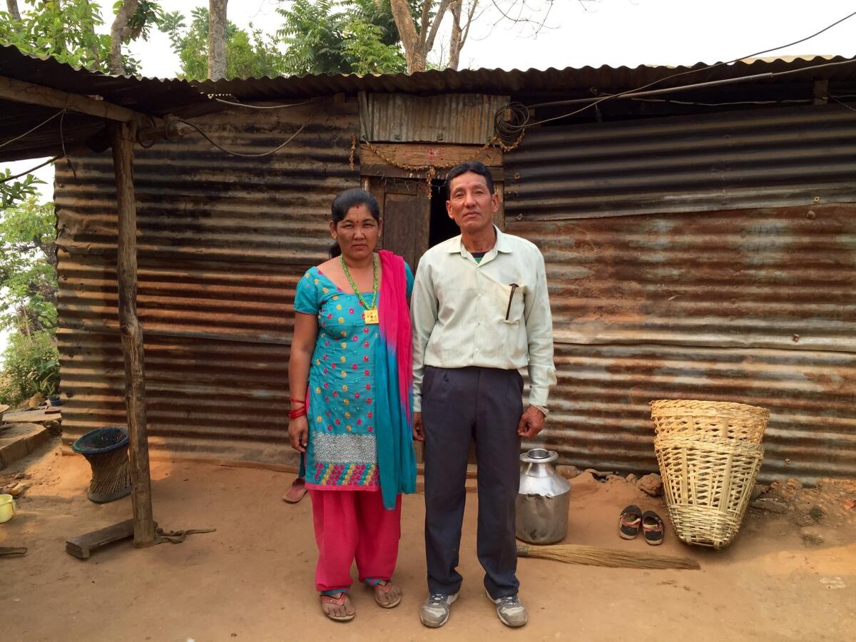 Raj Kumar Sahi and his wife, Madhu Sahi, outside their temporary home in Paslang, Nepal.